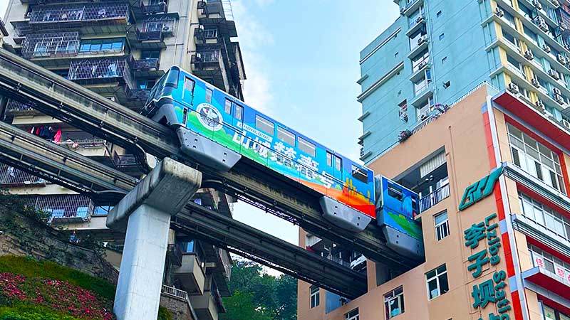 Liziba train passing through building in Chongqing