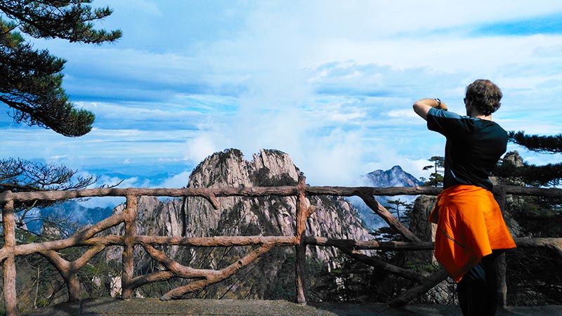 A Man Taking Photos of Huangshan